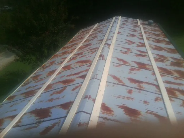 Rusted metal roof panels with new wood purlins before replacement — Storm Damage Roof Repair in San Diego by Roofing Brothers
