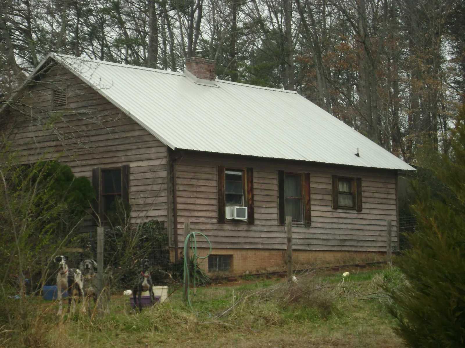 White metal roof on an old wood sided farmhouse, from a Metal Roof Installation job in San Diego